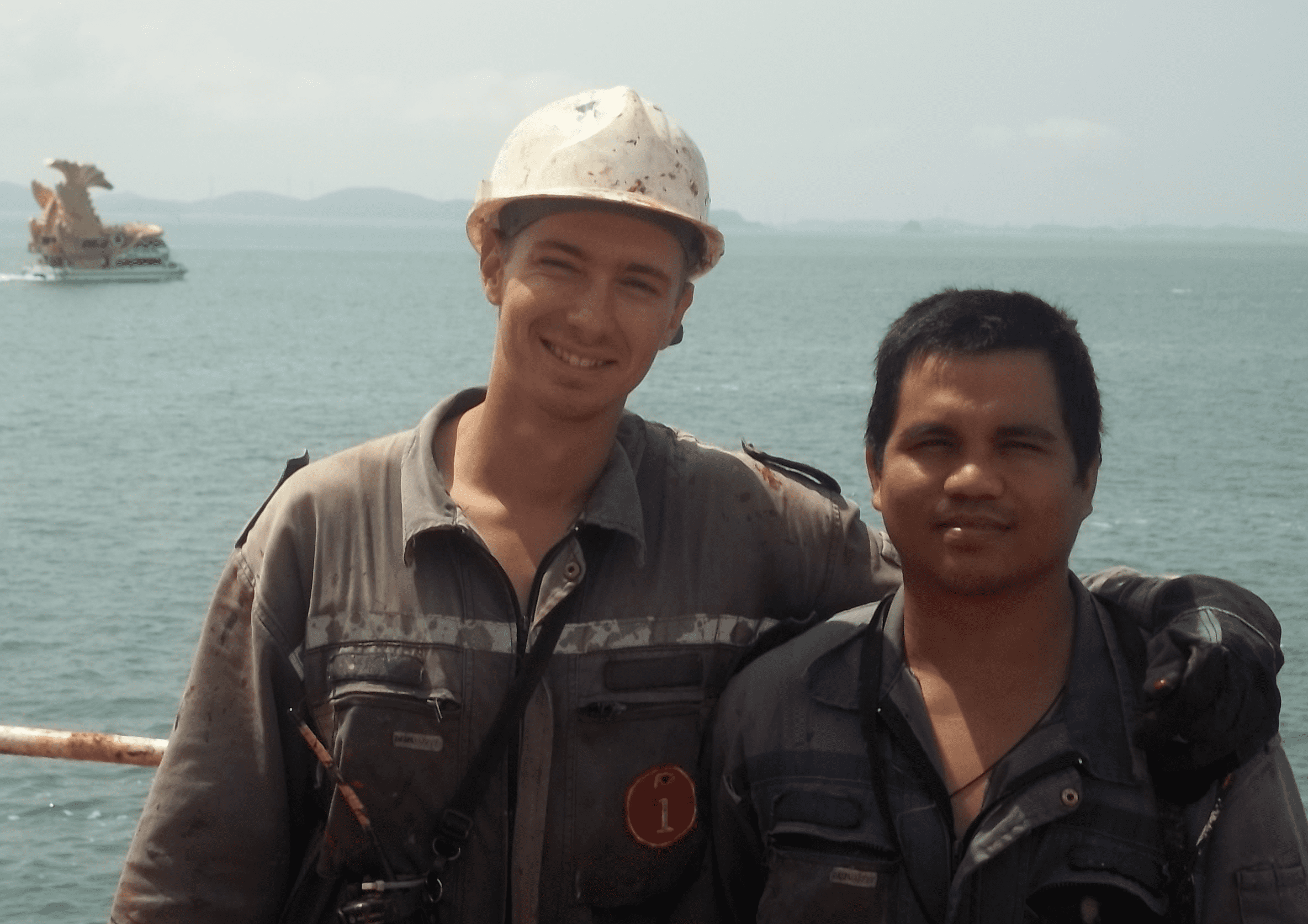 Two seamen in the middle of work day on the coast of Singapore